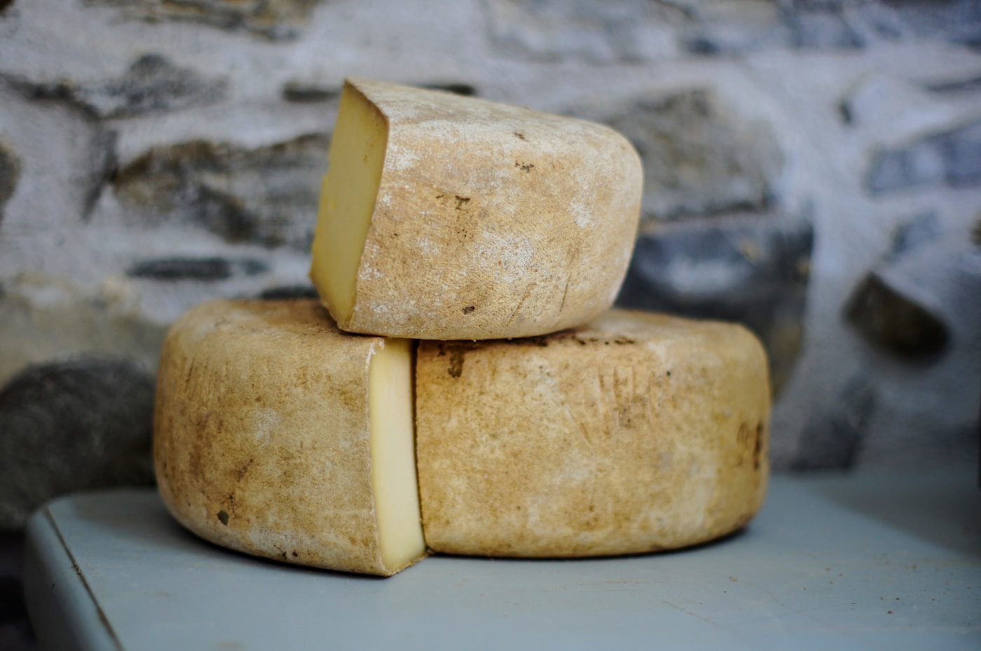Several French cheese families arranged from soft and pressed to blue styles.